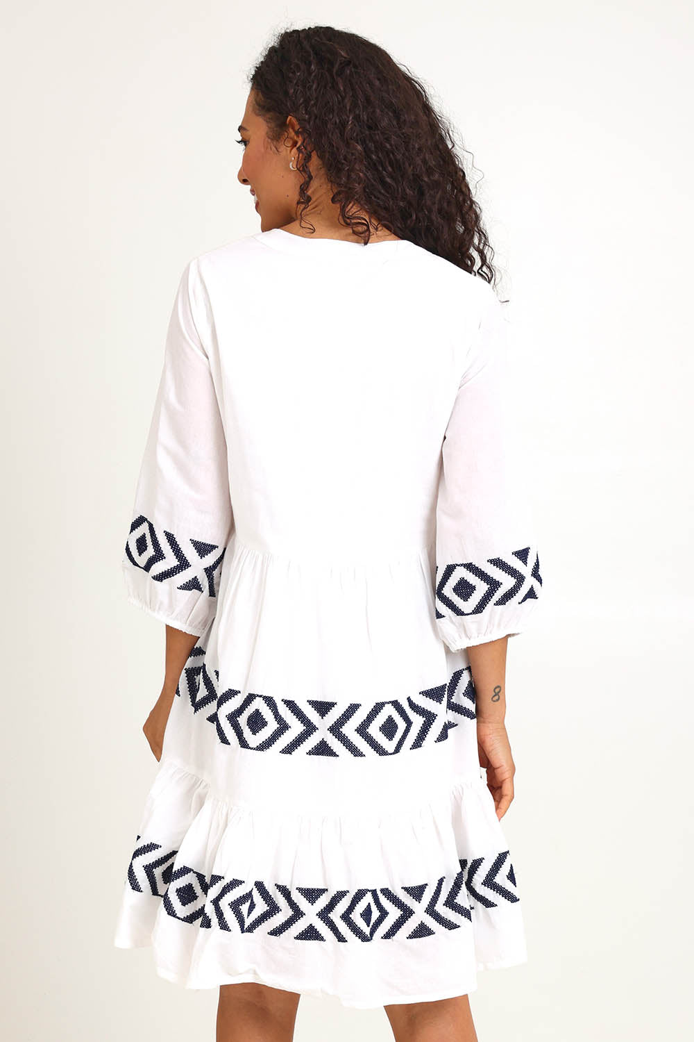 Model Pamelar wearing size 10 of the Essentials Embroidered Layers Cotton Dress - White in colour White, from the back