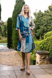 A model wearing the Alberobello Organic Cotton Dress in colour Blue (Blue), from the front, showing the whole outfit