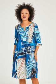 Model Olivia wearing size 10 of the Alberobello Organic Cotton Dress in colour Blue (Blue), from the front, cropped image