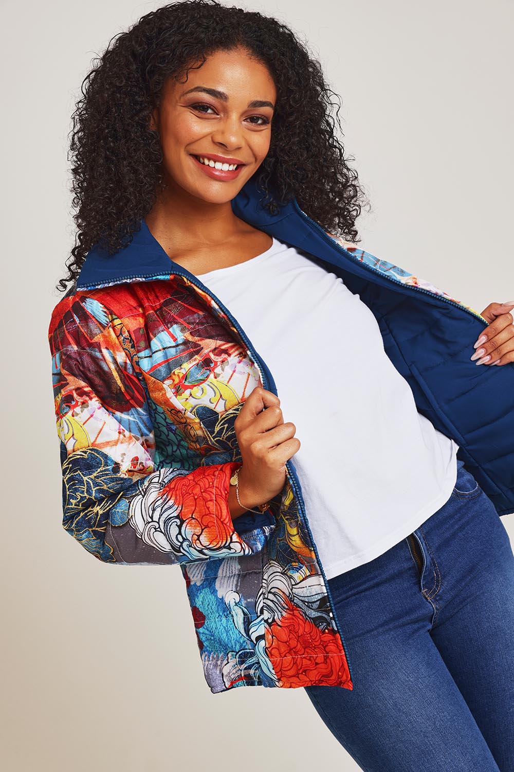 Model Ziara wearing size 10 of the Oriental Nights Puffer Reversible Coat in colour Oriental, from the front, cropped image