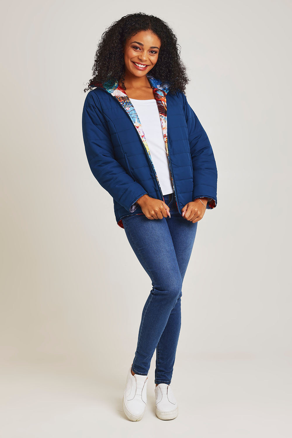 Model Ziara wearing size 10 of the Oriental Nights Puffer Reversible Coat in colour Oriental, from the front, showing the whole outfit