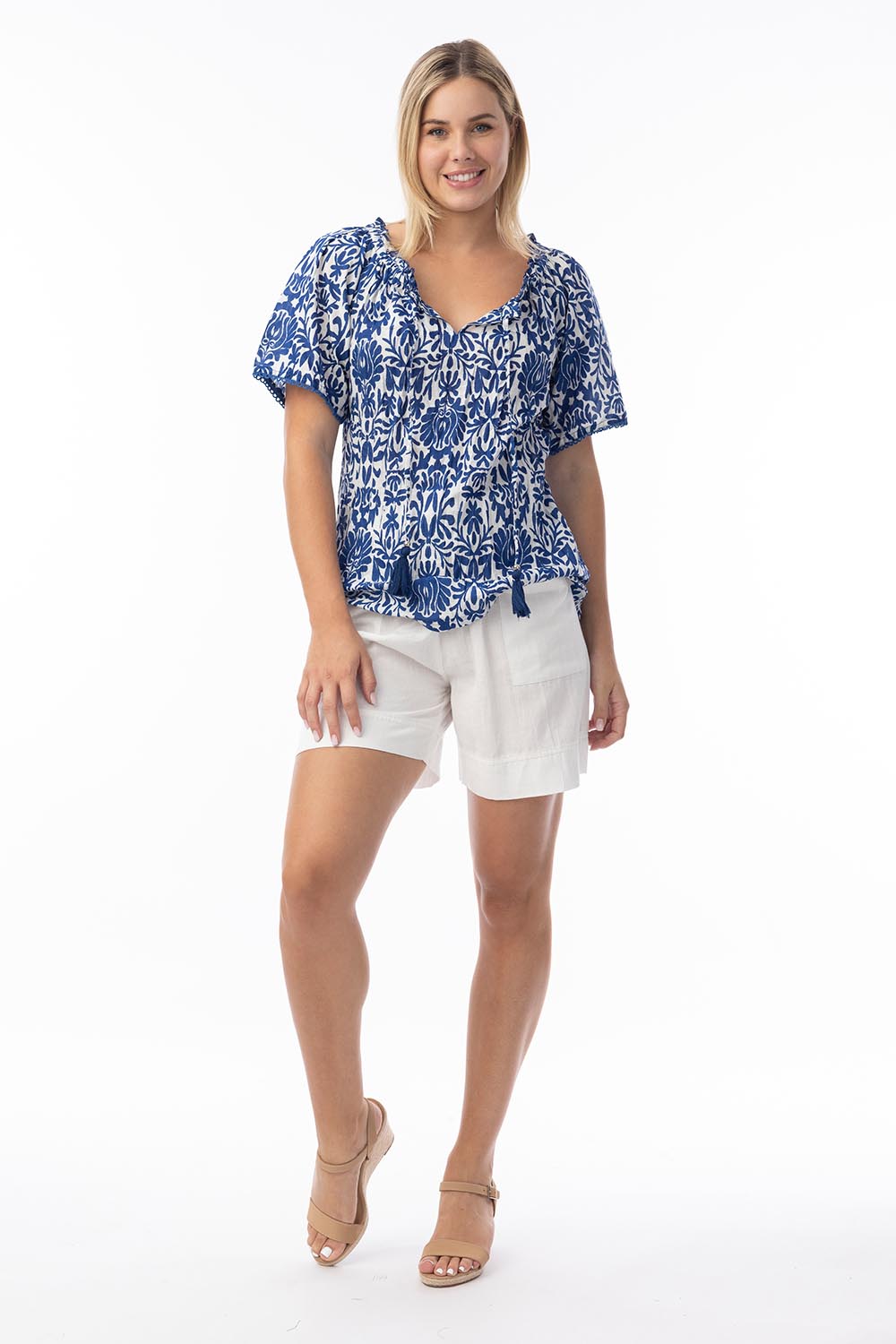 A model wearing the Frill Neckline Cotton Top in colour Buzios, from the front, showing the whole outfit