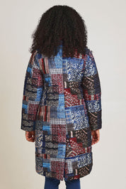 Model Ziara wearing size 10 of the Kantha Reversible Patch Puffer Coat in colour Kantha (Blue), from the back