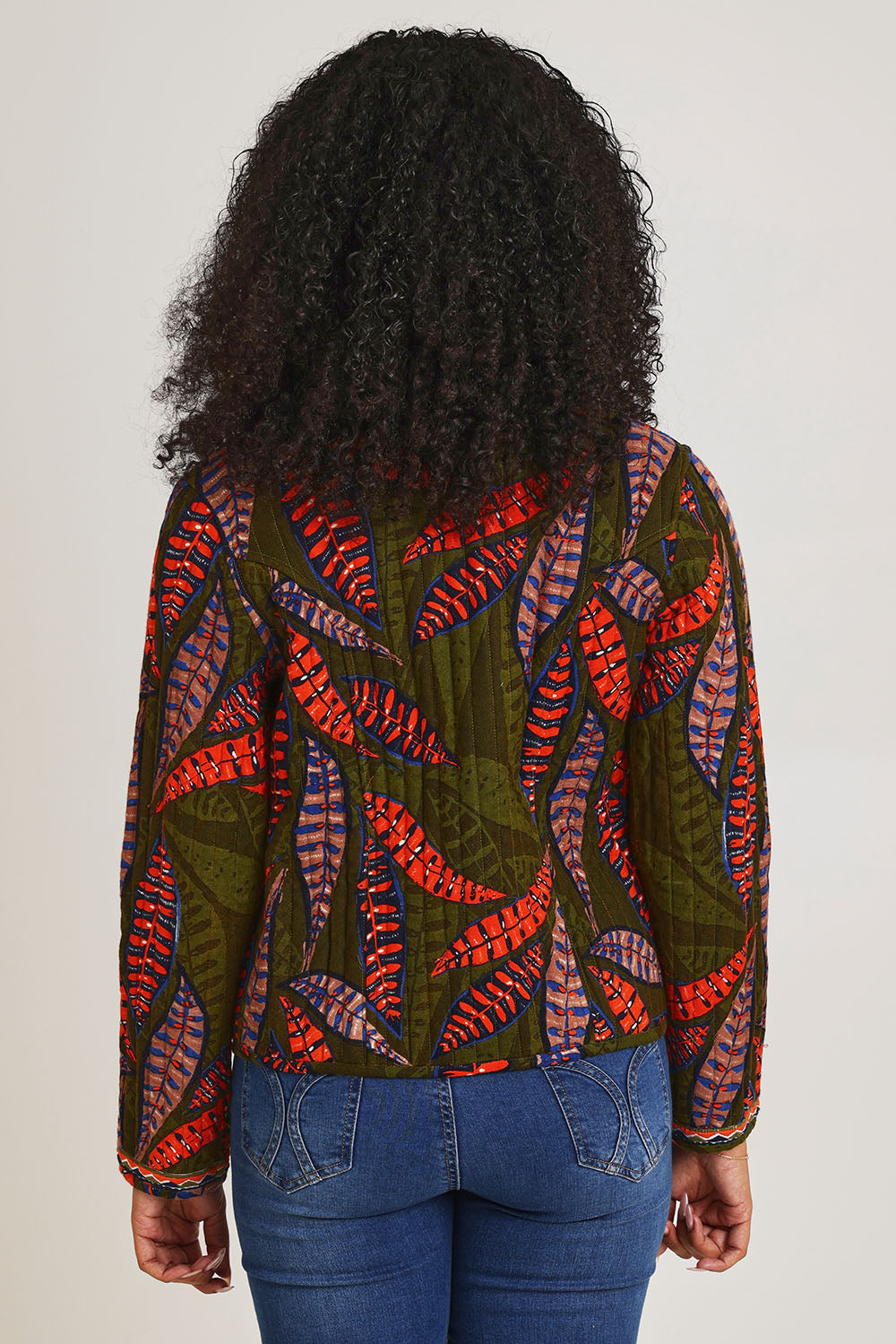 Model Ziara wearing size 10 of the Reckless Reversible Jacket in colour Reckless (Green), from the back