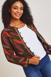 Model Ziara wearing size 10 of the Reckless Reversible Jacket in colour Reckless (Green), from the front, cropped image