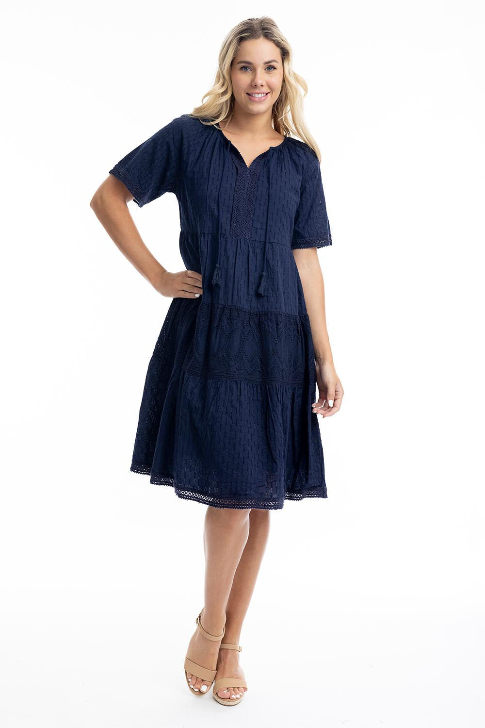 A model wearing the Essential Broderie Layers Cotton Dress in colour Navy (Blue), from the front, showing the whole outfit