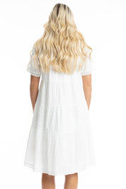 A model wearing the Essential Broderie Layers Cotton Dress in colour White (White), from the back