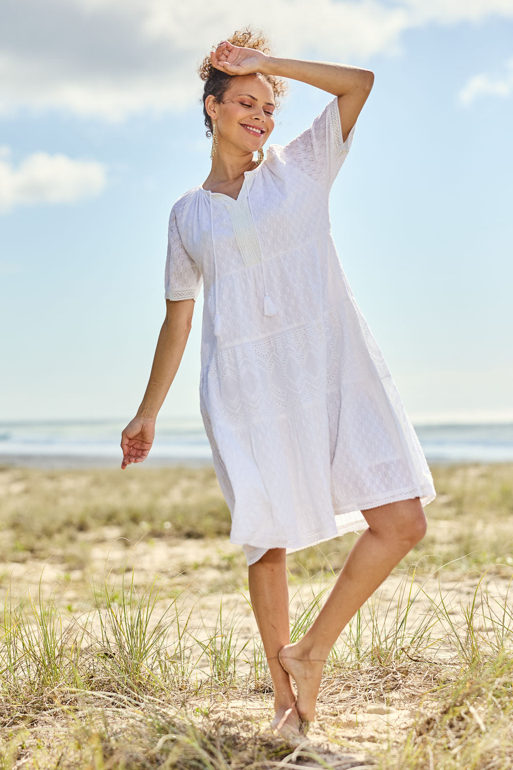 Model Lala wearing size 10 of the Essential Broderie Layers Cotton Dress in colour White (White), from the front, showing the whole outfit