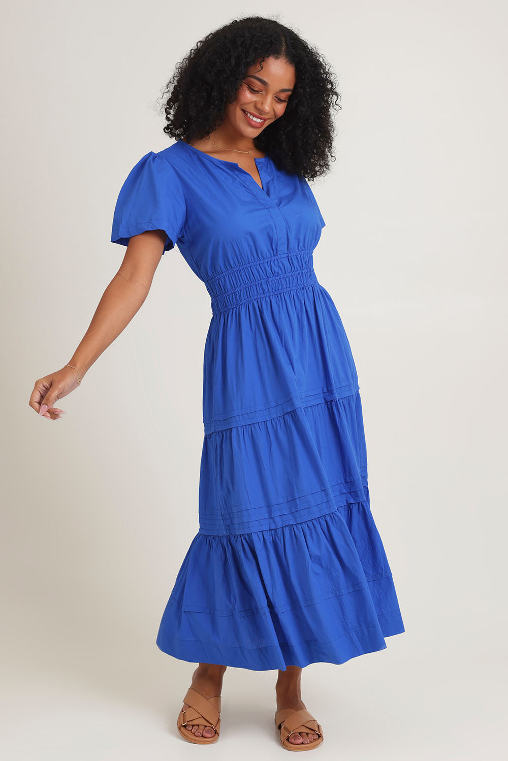 Model Ziara wearing size 10 of the Essentials Organic Cotton Poplin Maxi Ruched Waist Dress in colour Blue (Blue), from the front, showing the whole outfit