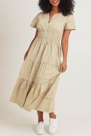 Model Ziara wearing size 10 of the Essentials Organic Cotton Poplin Maxi Ruched Waist Dress in colour Sand, from the front, cropped image