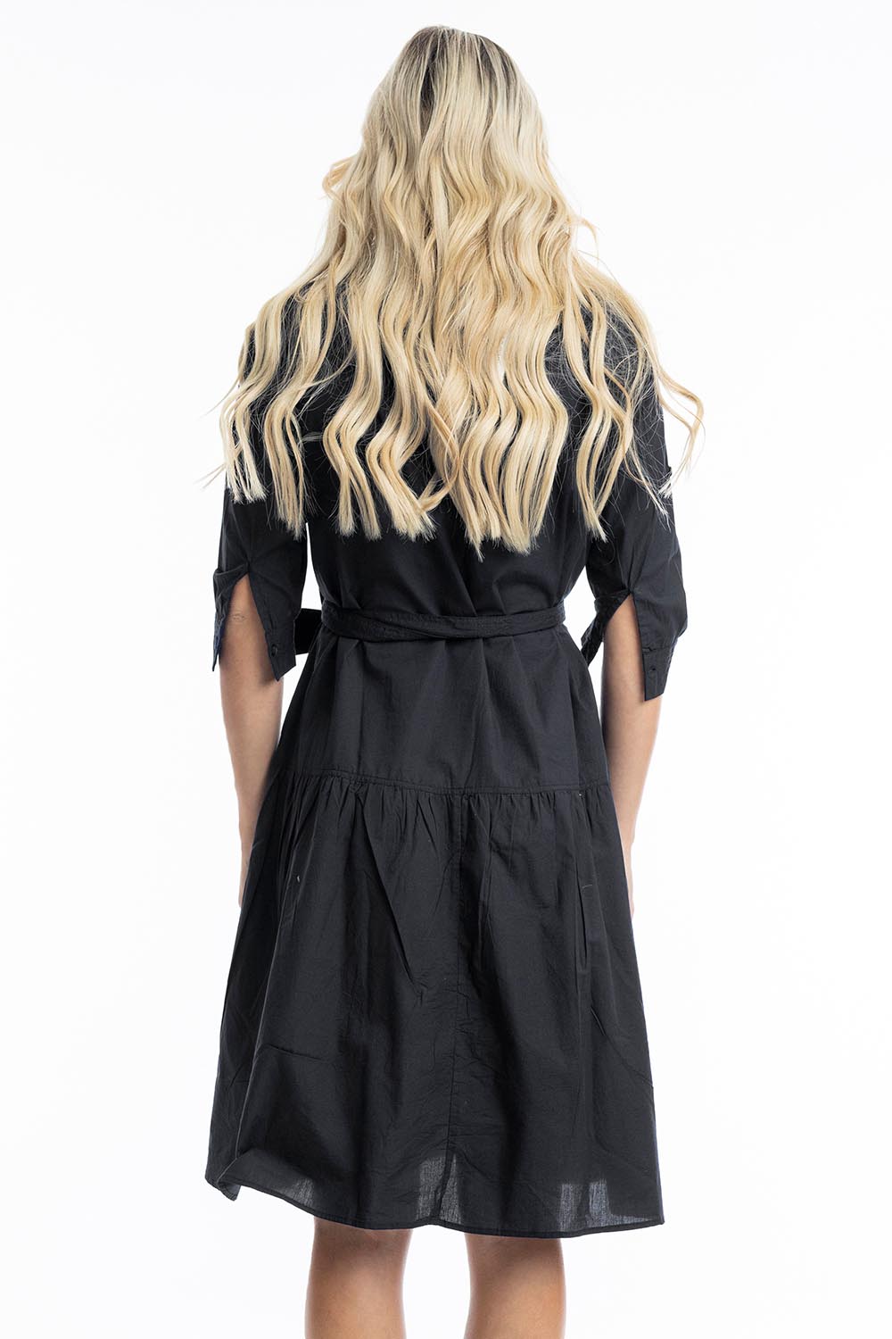 A model wearing the Essentials Organic Cotton Poplin Button through Belt dress in colour Black (Black), from the back