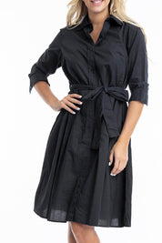 A model wearing the Essentials Organic Cotton Poplin Button through Belt dress in colour Black (Black), from the front, cropped image