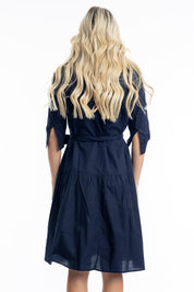 A model wearing the Essentials Organic Cotton Poplin Button through Belt dress in colour Navy (Blue), from the back