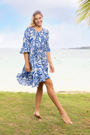A model wearing the Hayman Cotton Blend Pinch Pleat Frill Sleeve Dress in colour Blue (Blue), from the front, showing the whole outfit