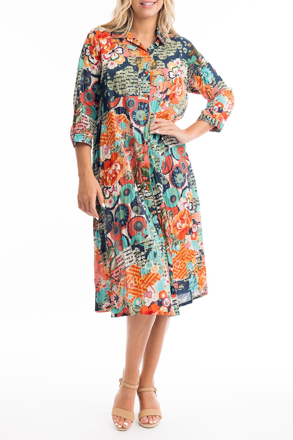 A model wearing the Yakushima Organic Cotton Patch Dress in colour Print (Blue), from the front, cropped image