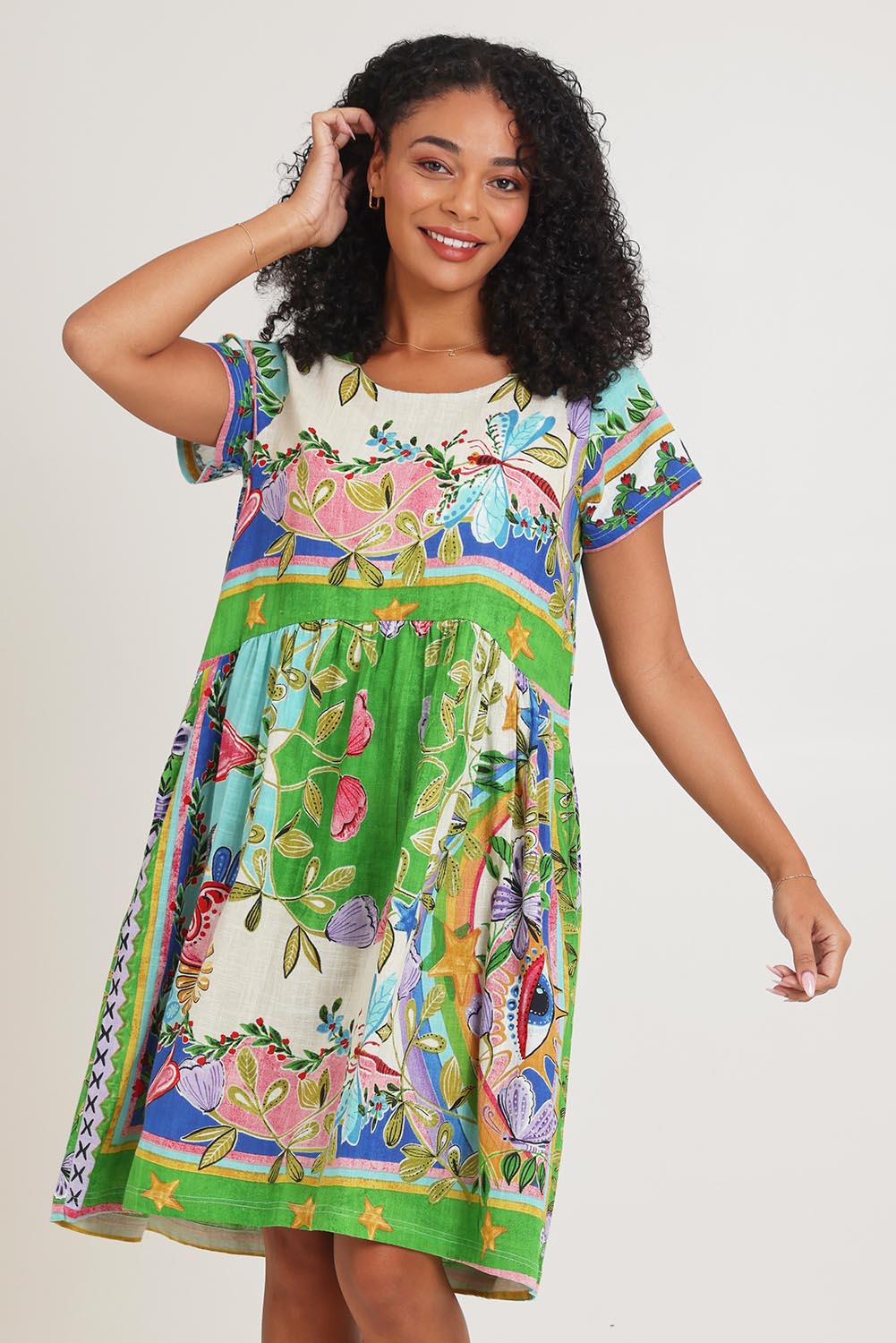 Model Ziara wearing size 10 of the Boxy Cotton Dress in colour Santafe, from the front, cropped image