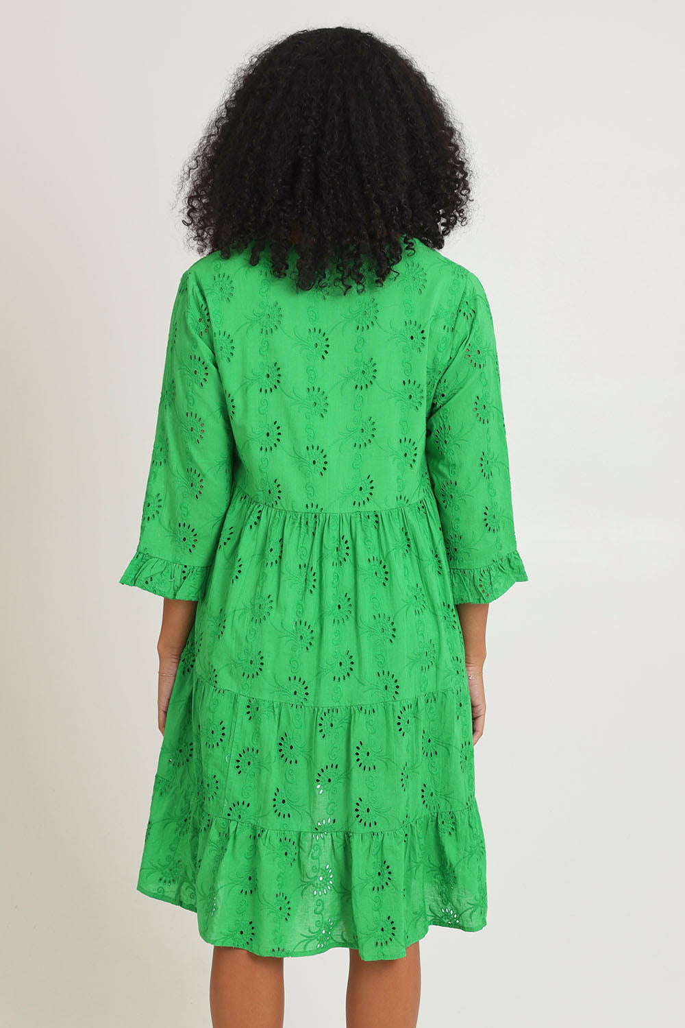 Model Ziara wearing size 10 of the Essentials Frill Hem Broderie Cotton Dress in colour Green (Green), from the back