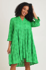 Model Ziara wearing size 10 of the Essentials Frill Hem Broderie Cotton Dress in colour Green (Green), from the front, cropped image