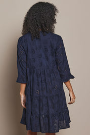 Model Ziara wearing size 10 of the Essentials Frill Hem Broderie Cotton Dress in colour Navy (Blue), from the back