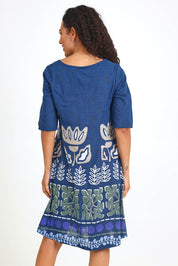 Model Pamelar wearing size 10 of the Contemporary Dress – Blue in colour Blue, from an angle