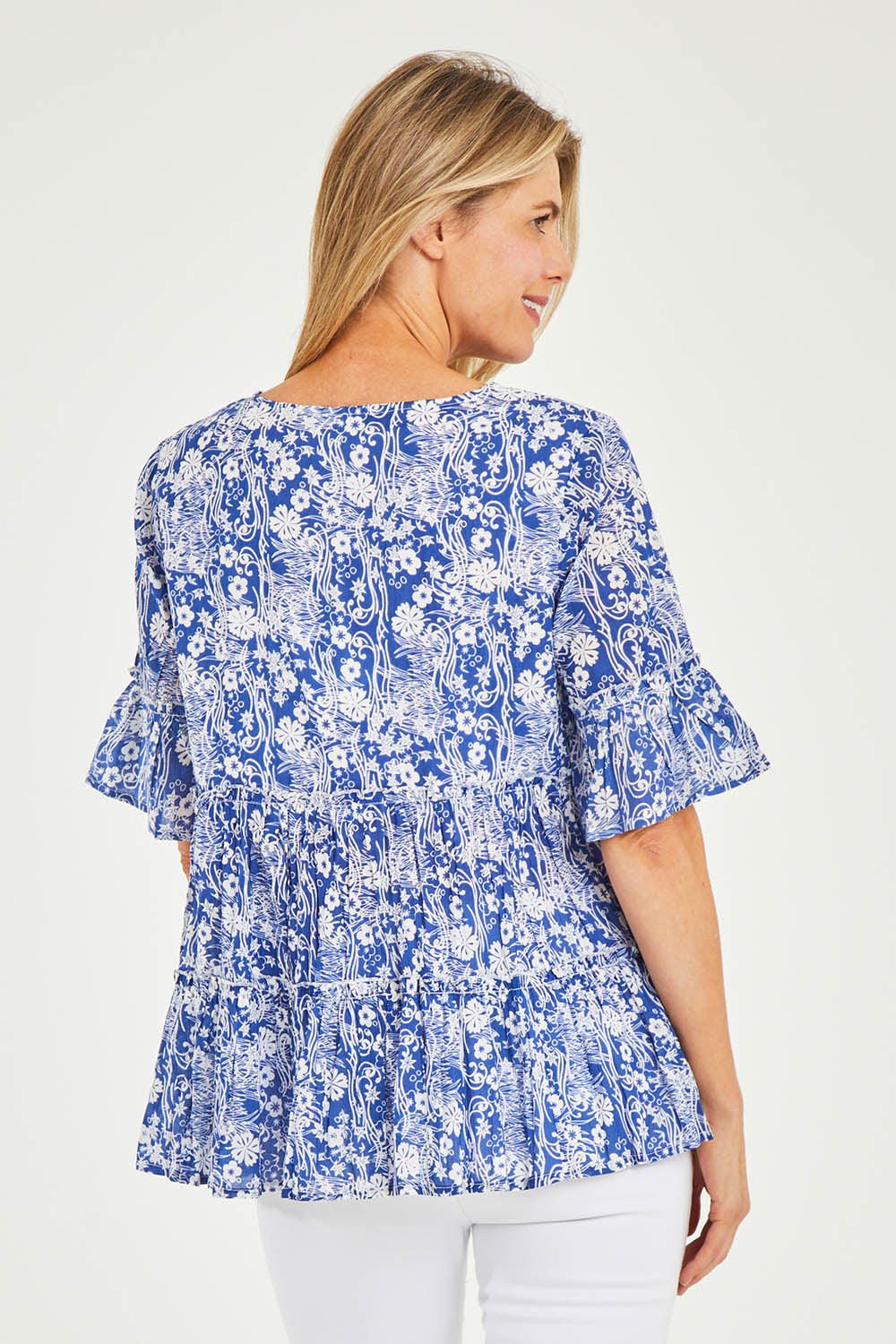 Model Kelly wearing size 10 of the Cappadocia Organic Cotton Frill Sleeve Top in colour Blue (Blue), from the back