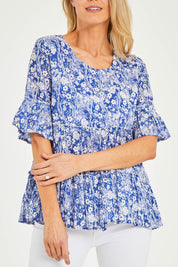 Model Kelly wearing size 10 of the Cappadocia Organic Cotton Frill Sleeve Top in colour Blue (Blue), from the front, cropped image