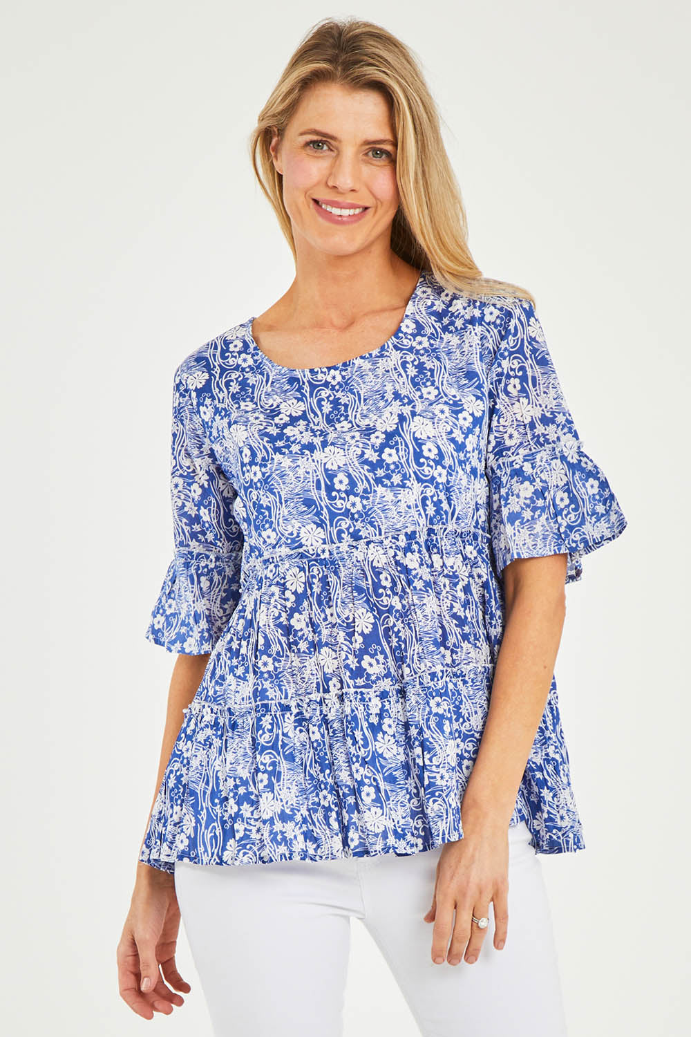 Model Kelly wearing size 10 of the Cappadocia Organic Cotton Frill Sleeve Top in colour Blue (Blue), from the front, cropped image