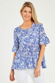 Model Kelly wearing size 10 of the Cappadocia Organic Cotton Frill Sleeve Top in colour Blue (Blue), from the front, cropped image