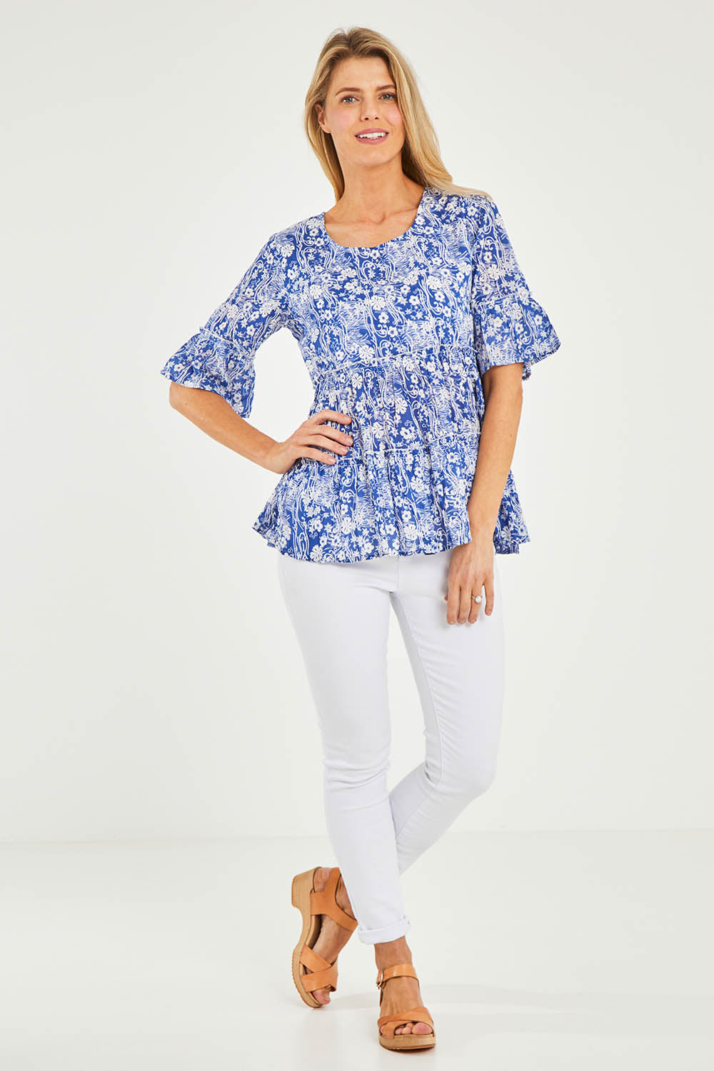 Model Kelly wearing size 10 of the Cappadocia Organic Cotton Frill Sleeve Top in colour Blue (Blue), from the front, showing the whole outfit