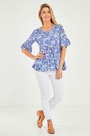 Model Kelly wearing size 10 of the Cappadocia Organic Cotton Frill Sleeve Top in colour Blue (Blue), from the front, showing the whole outfit