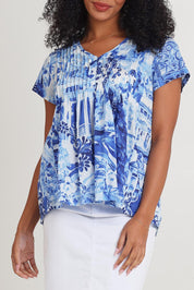 Model Ziara wearing size 10 of the Pleated Cotton Top in colour Okayama (Blue), from the front, cropped image