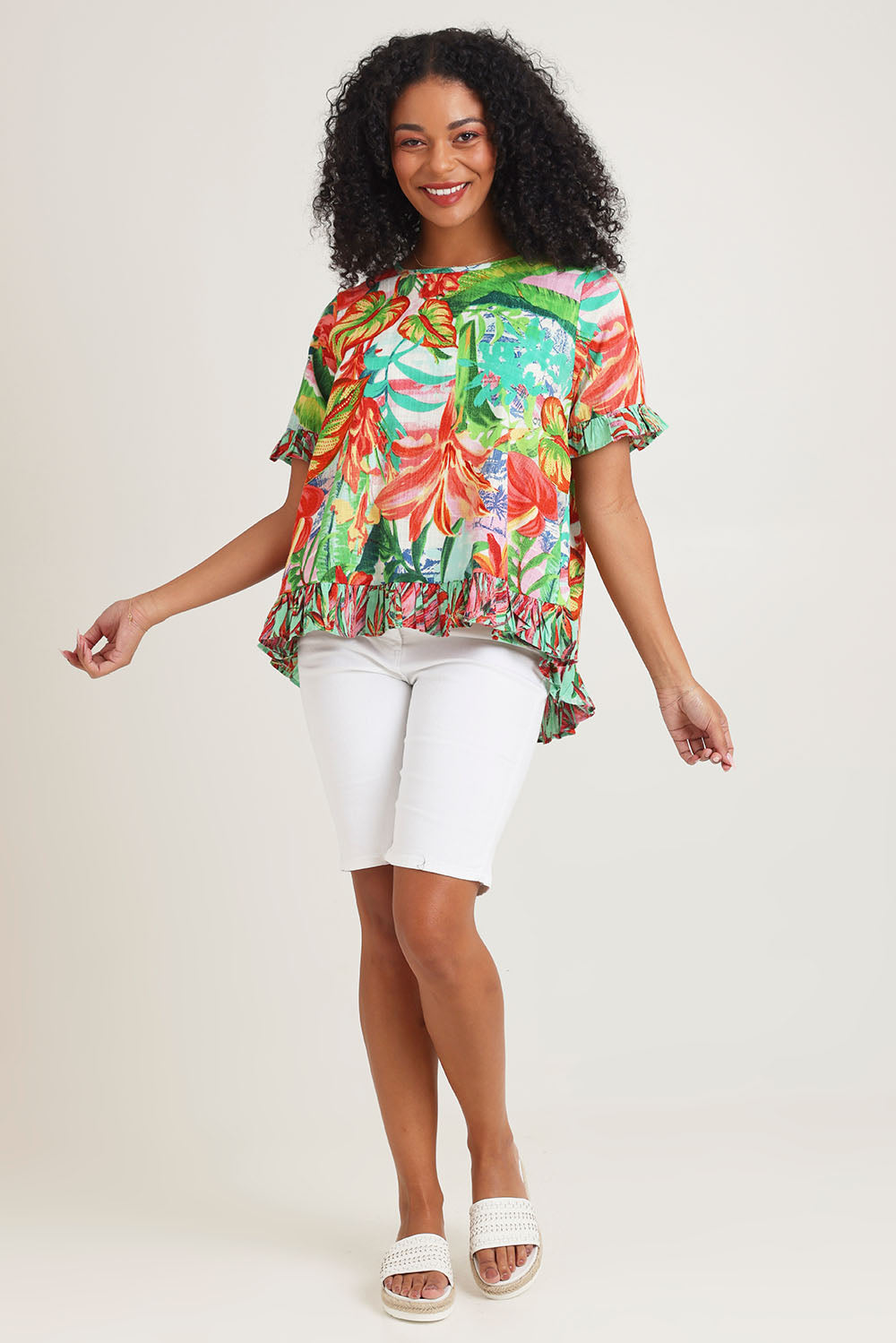 Model Ziara wearing size 10 of the Cotton Frill Top in colour Equador, from the front, showing the whole outfit