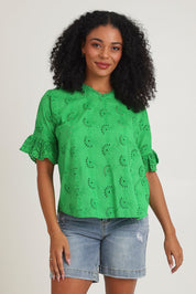 Model Ziara wearing size 10 of the Essentials Broderie Cotton Top in colour Green (Green), from the front, cropped image