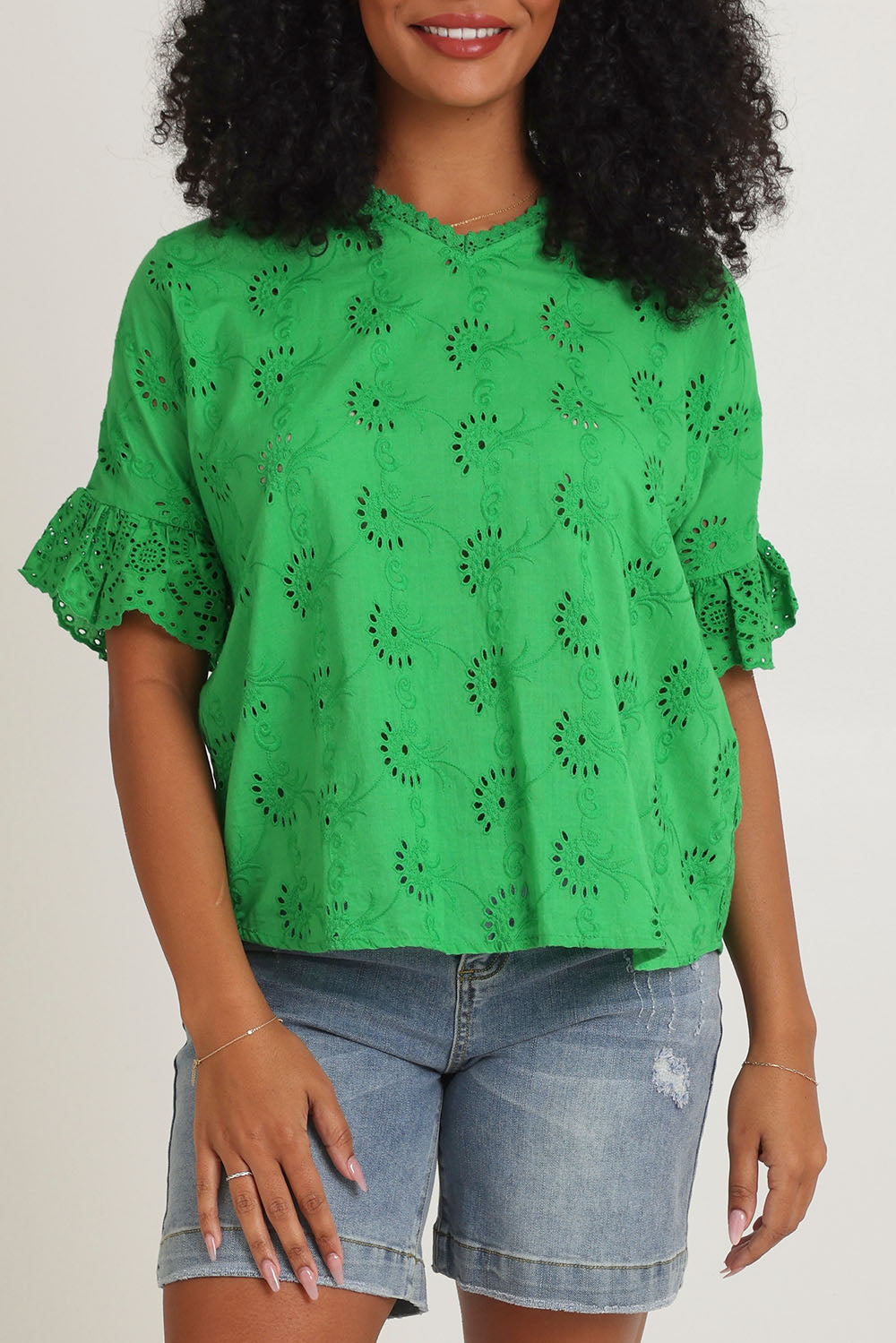 Model Ziara wearing size 10 of the Essentials Broderie Cotton Top in colour Green (Green), from the front, cropped image