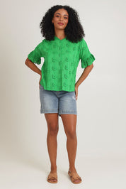 Model Ziara wearing size 10 of the Essentials Broderie Cotton Top in colour Green (Green), from the front, showing the whole outfit