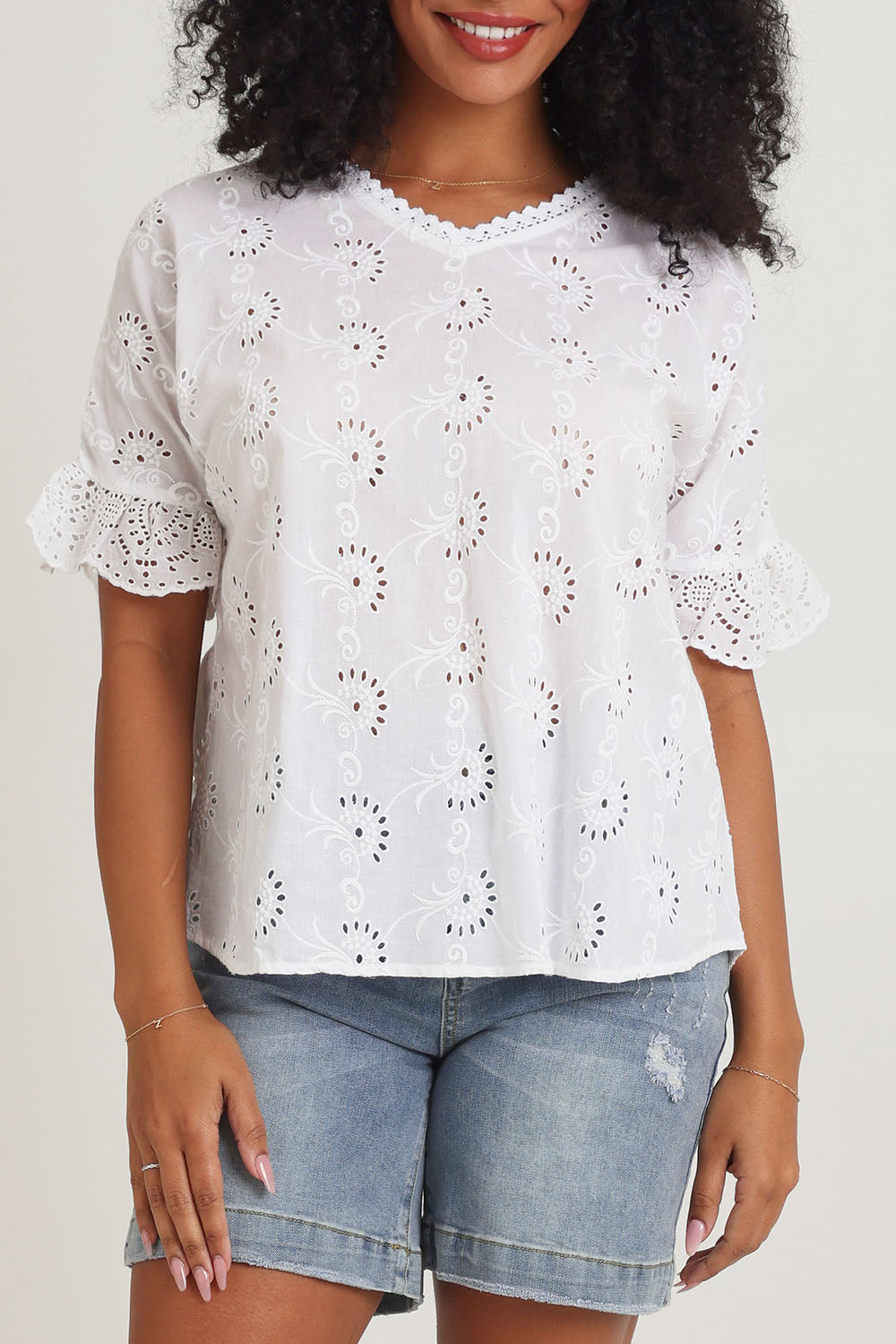 Model Ziara wearing size 10 of the Essentials Broderie Cotton Top in colour White (White), from the front, cropped image