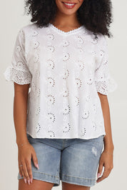 Model Ziara wearing size 10 of the Essentials Broderie Cotton Top in colour White (White), from the front, cropped image