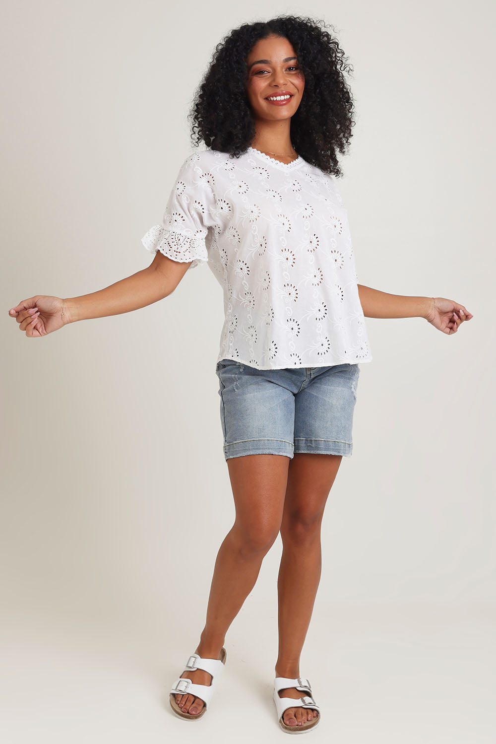 Model Ziara wearing size 10 of the Essentials Broderie Cotton Top in colour White (White), from the front, showing the whole outfit