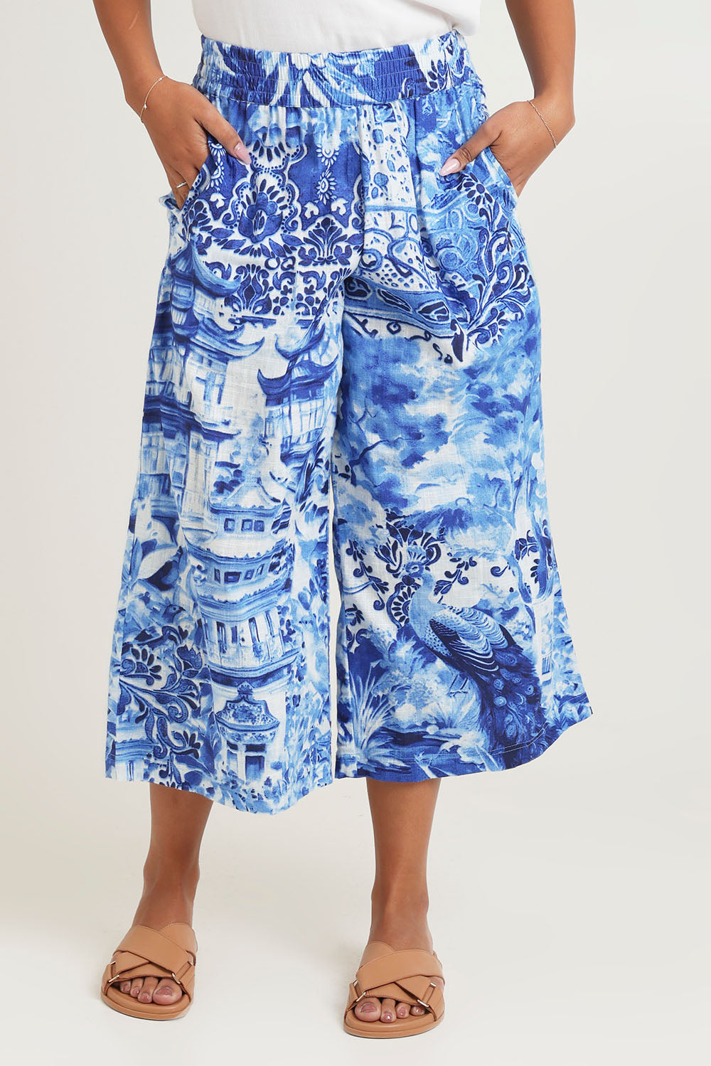 Model Ziara wearing size 10 of the Okayama Cotton Pant in colour Okayama (Blue), from the front, cropped image
