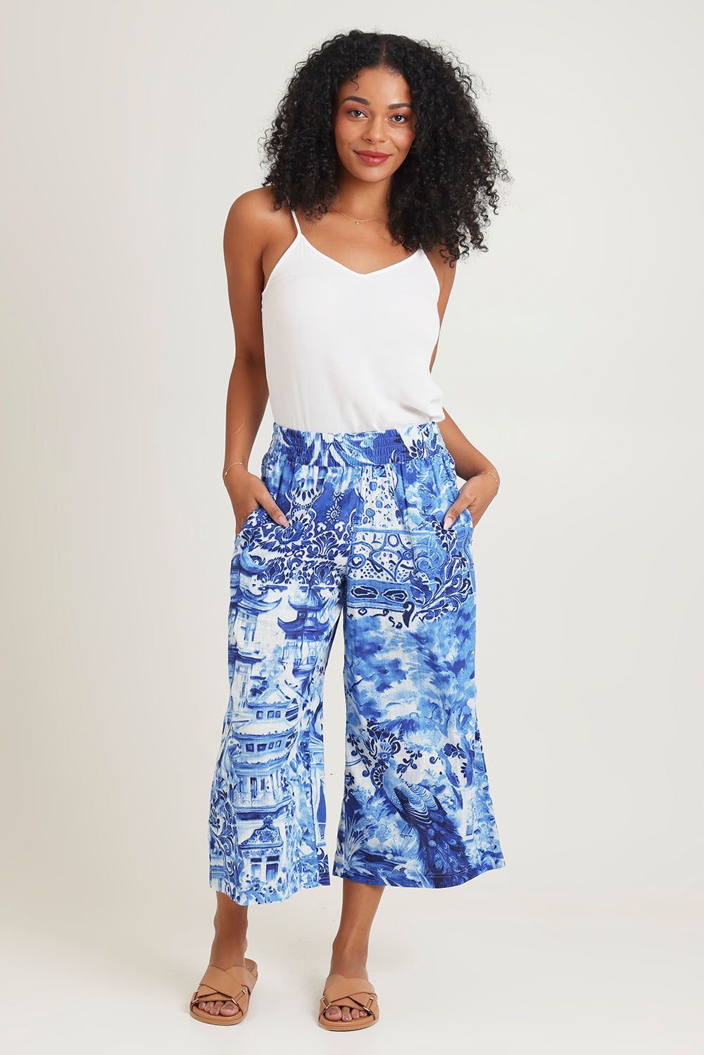 Model Ziara wearing size 10 of the Okayama Cotton Pant in colour Okayama (Blue), from the front, showing the whole outfit