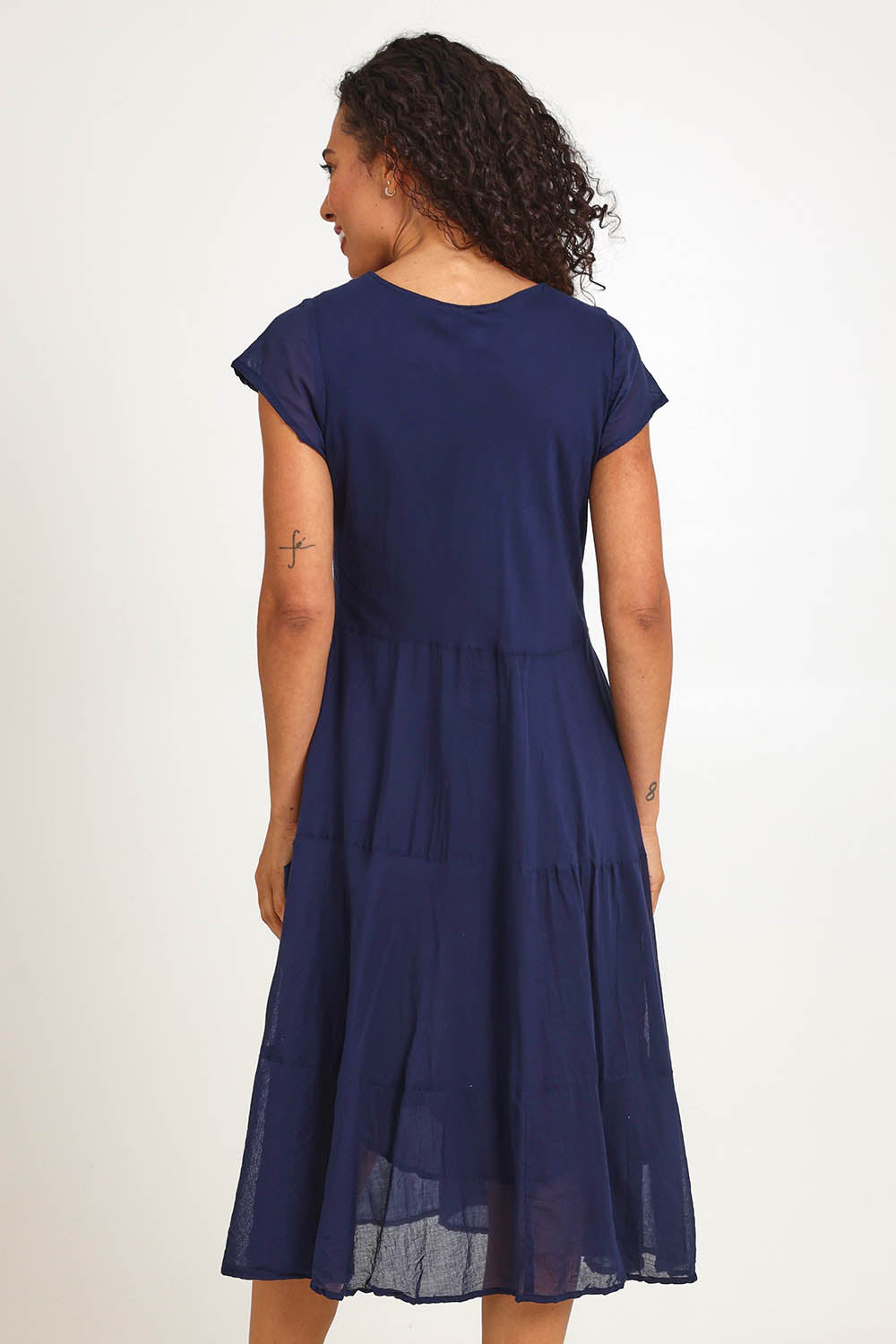 Model Pamelar wearing size 10 of the Essentials Bias Pockets Cotton Dress - Navy in colour Navy, from the back