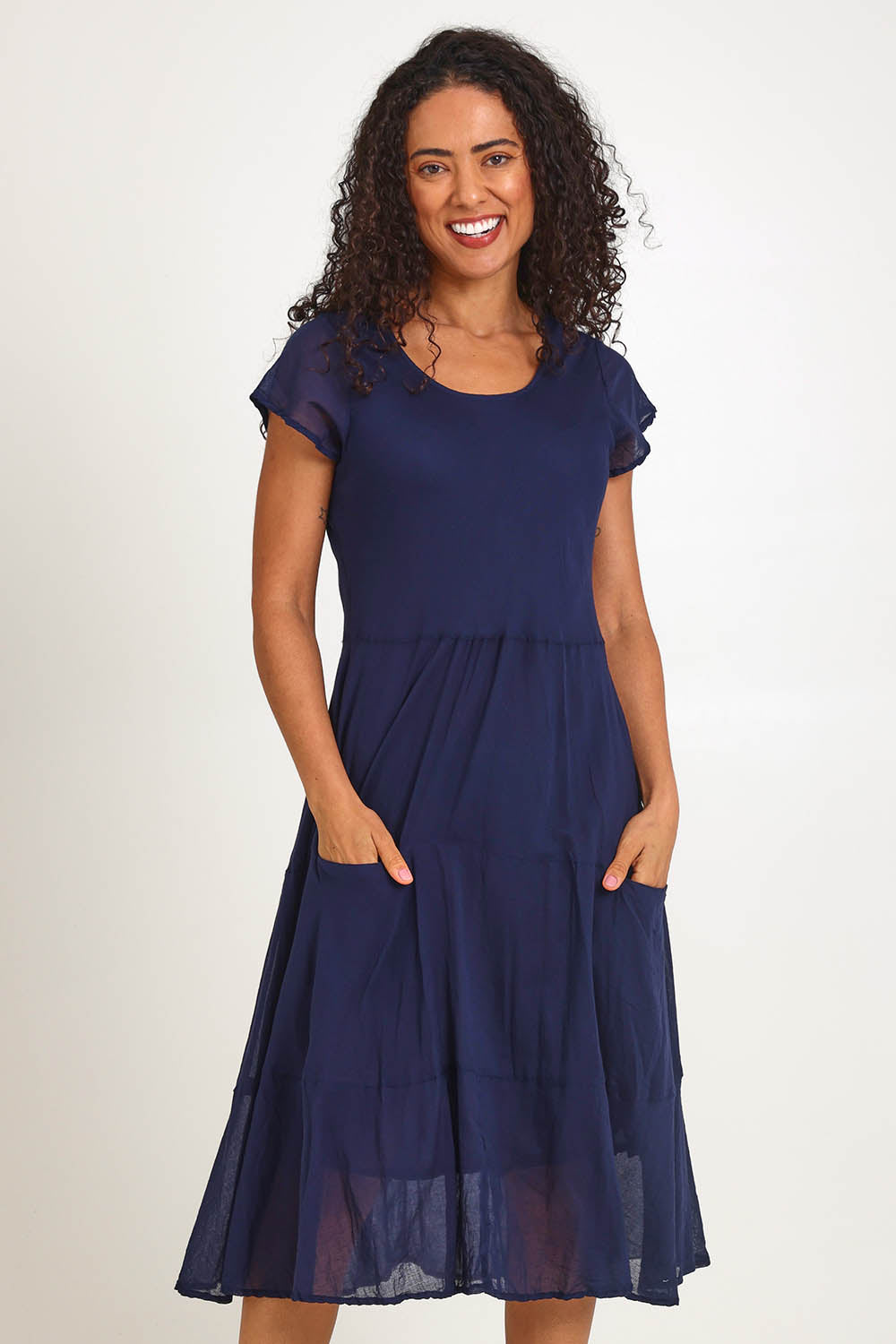 Model Pamelar wearing size 10 of the Essentials Bias Pockets Cotton Dress - Navy in colour Navy, from the front
