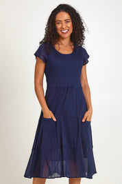 Model Pamelar wearing size 10 of the Essentials Bias Pockets Cotton Dress - Navy in colour Navy, from the front