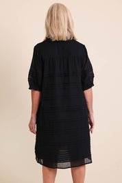 Model Sandys wearing size 10 of the Essentials Pleated Cotton Dress - Black in colour Black, from the back