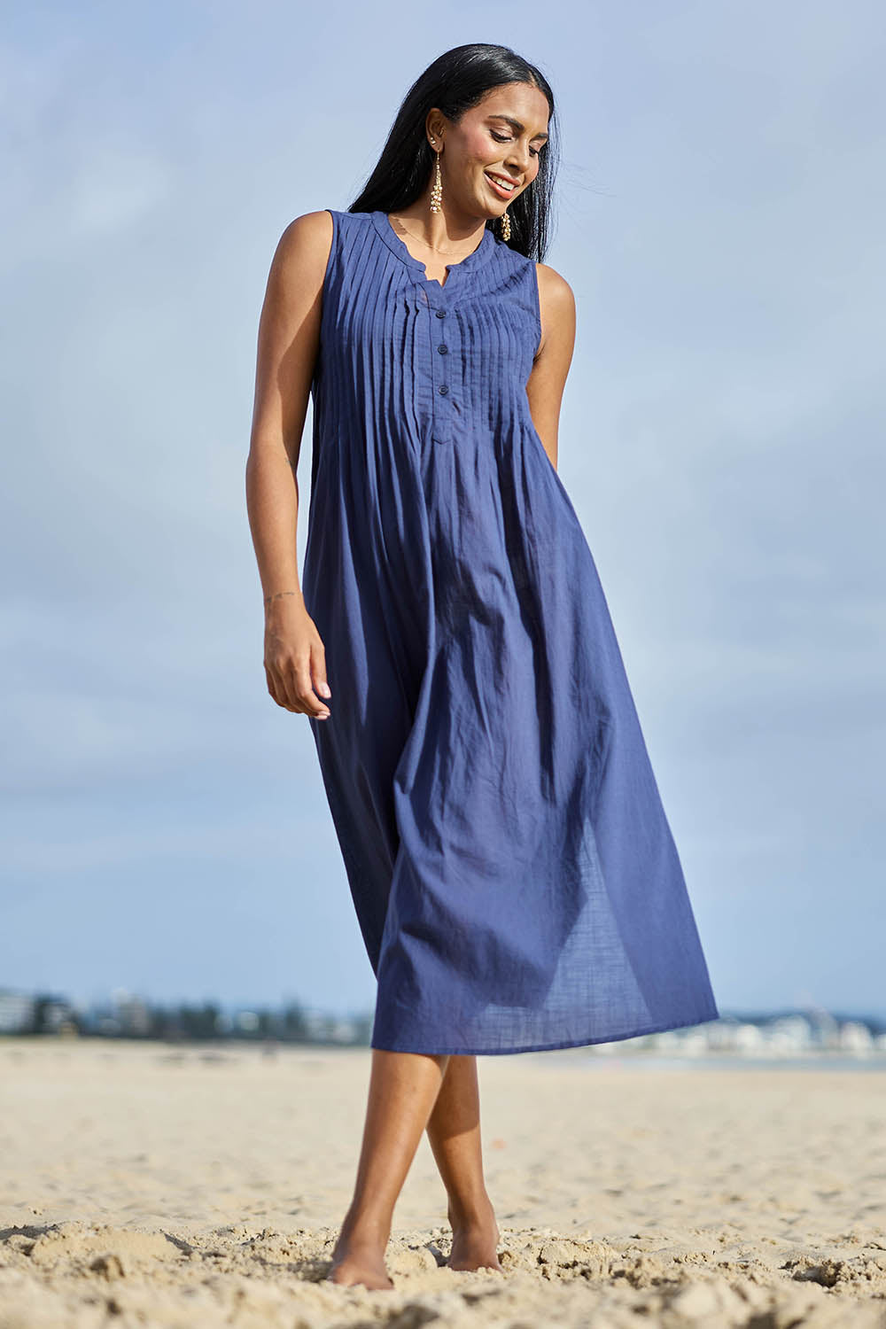 Model Eshan wearing size 10 of the Essentials Pleated Cotton Maxi Dress - Navy in colour Navy, from the front