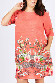 Model Mae wearing size 18 of the Bologna Shift Dress in colour Floral (Red), from the front, cropped image