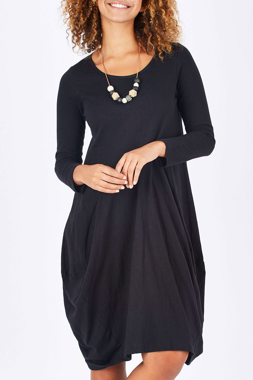 Model Summer wearing size 10 of the Bubble Dress in colour Black (Black), from the front, cropped image