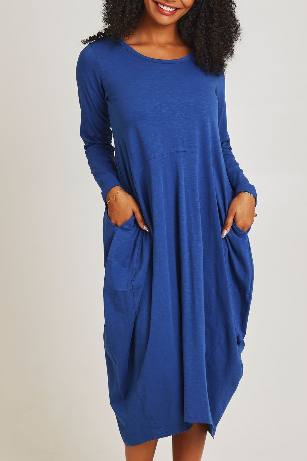 Model Ziara wearing size 10 of the Cotton Blend Bubble Dress in colour Blue (Blue), from the front, cropped image