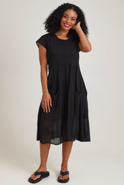 Model Ziara wearing size 10 of the Essentials Bias Pockets Cotton Dress in colour Black (Black), from the front, showing the whole outfit