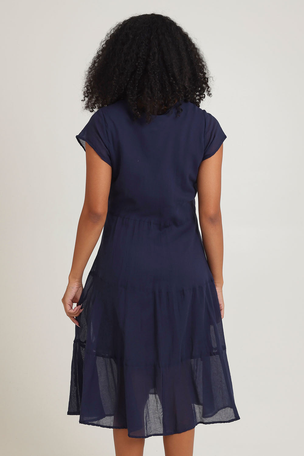 Model Ziara wearing size 10 of the Essentials Bias Pockets Cotton Dress in colour Navy (Blue), from the back
